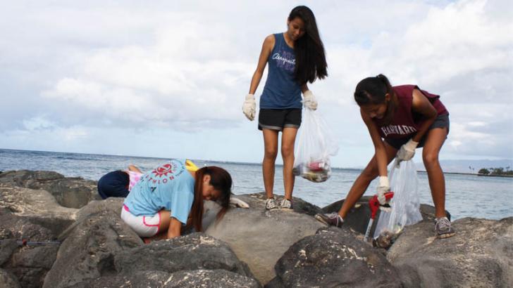 girls cleaning up beach