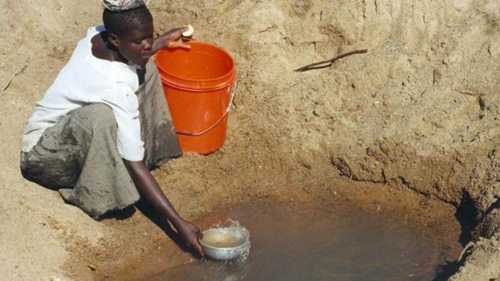 woman collecting polluted water